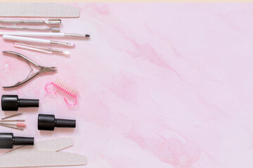 Flat lay of manicure tools, gel bottles, nail brushes and files on a soft pink marble background. Ideal for beauty product ads, nail salons, courses, or blog visuals.