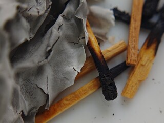 Macro Still Life Burnt Matchsticks and Delicate Ash Remains on White Surface.