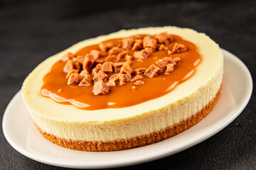 Cheesecake salted caramel sweet dessert fresh delicious gourmet food background on the table rustic food top view copy space