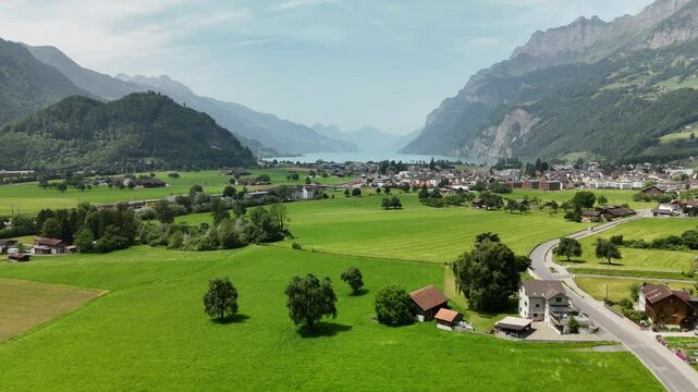 Scenic Aerial View of a Valley with Green Fields and Mountain Landscape in Switzerland near Flums, Berschis, and Walenstadt in the Canton of St. Gallen &ndash; Drone Footage