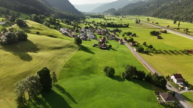 Scenic Aerial View of a Valley with Green Fields and Mountain Landscape in Switzerland near Flums, Berschis, and Walenstadt in the Canton of St. Gallen &ndash; Drone Footage