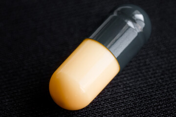  Macro shot of a two-tone medicinal capsule, emphasizing its role in healthcare and treatment. Photo. Selective focus