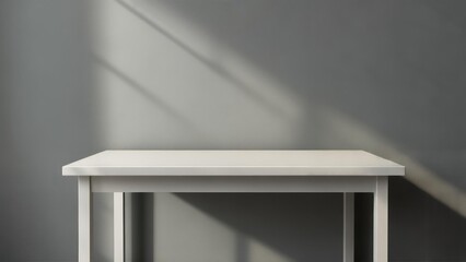 Fototapeta premium Minimalist white table against gray wall with sunlight shadows