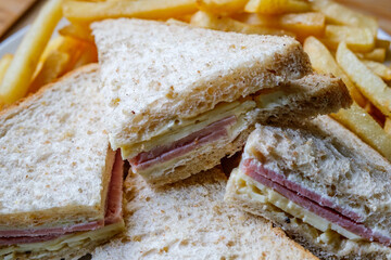 Homemade Ham and Cheese Sandwich In Sliced Brown Bread With Chips Or Fries