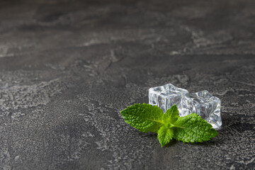 Mint and ice on texture background. Green fresh mint and ice cube. Mint leaves, ice cube and water...