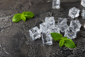 Mint and ice on texture background. Green fresh mint and ice cube. Mint leaves, ice cube and water...