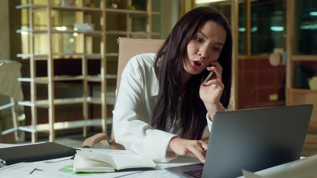 Stressful businesswoman Asian busy multitasking business woman in office call mobile phone writing notes deadline tasks Korean Japanese Chinese female girl planner talking cellphone work online laptop