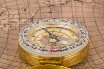 Compass on old map as background.