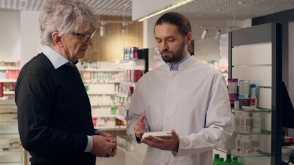 Caucasian pharmacist advice customer medication pills vitamins drugs antibiotics in pharmacy doctor help old senior man patient support medicine consultation health care recommendation in drugstore - Powered by Adobe