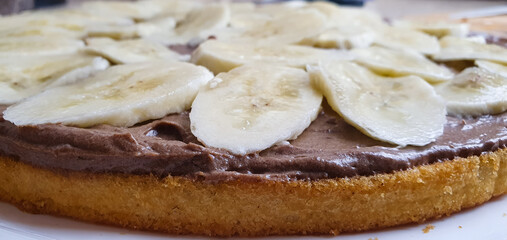 Preparation of chocolate banana cake. Creamy sponge cake,chocolate cake with banana slices,cake recipe.