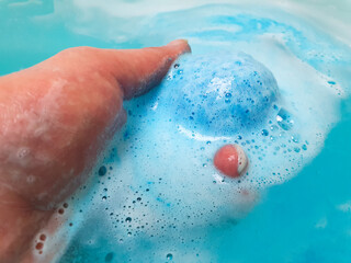 Bath bomb, round salt sphere to dissolve in water, bathing,hygiene,bubbling ball in the bathtub.