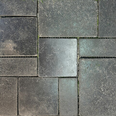 Natural black stone marble tiles in square and rectangular pattern. Outdoor textured honed tiles in black or dark grey color with grouts. Wall or floor tiles seamless background texture.