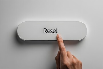 Finger pressing a reset button