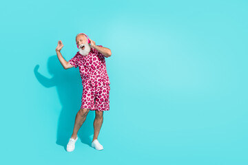 Full body photo of attractive senior bearded man dance sing headphones dressed pink leopard print...