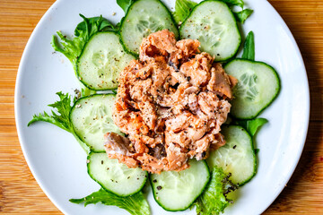 Red Salmon Fish With Cucumber and Salad Leaves