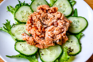 Red Salmon Fish With Cucumber and Salad Leaves