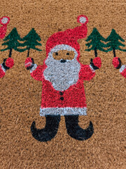 Santa claus doormat holding christmas trees and baubles welcoming guests