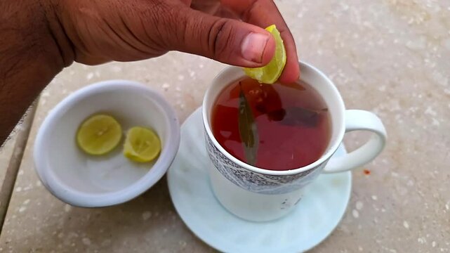 Squeezing Lemon on Herbal Green Tea Cup for Weight Loss &ndash; 240fps Slow Motion 4K Footage
