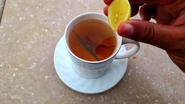 Squeezing Lemon on Herbal Green Tea Cup for Weight Loss &ndash; 240fps Slow Motion 4K Footage