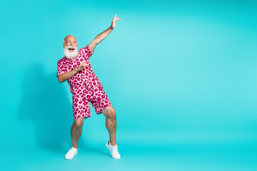Full body portrait of funky aged man dancing empty space wear leopard print costume isolated on turquoise color background