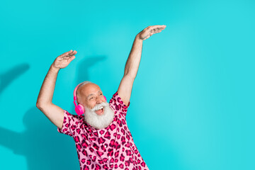 Photo of handsome bearded grandpa dance listen music headphones dressed stylish pink leopard print...