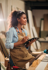 Business People African American Woman Managing Small Craft Business Using Tablet to Design...