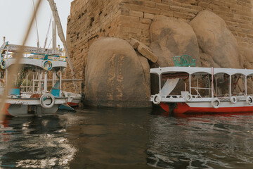Tourist boats docking near ancient egyptian temple on the nile river