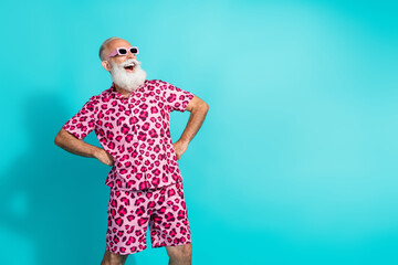 Photo of funny aged man empty space ad wear leopard print outfit isolated on teal color background