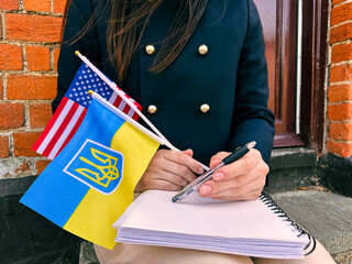 Woman with USA and Ukraine flags, concept of study, integration and future