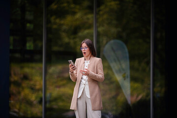 Surprised Businesswoman Reacting to Message on Phone