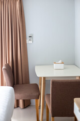 Room interior. Table with chairs and curtain on the window, neutral shades