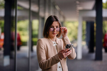 Professional Woman Using Smartphone in Modern Office Space