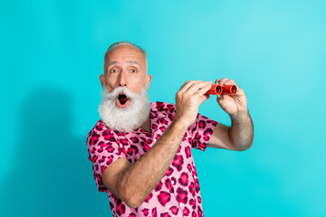 Photo of handsome bearded grandpa excited watch binoculars dressed stylish pink leopard print...