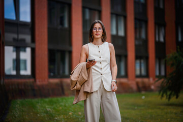 Fototapeta premium Confident Businesswoman Using Phone Outside Office