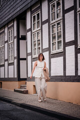 Confident Woman Walking by Historic European Building