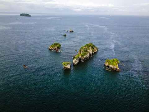 Aerial view of lush, green islets dotting the vast, dark expanse of the Limbe River near Bota Island, South West, Cameroon, Limbe, South West, Cameroon.