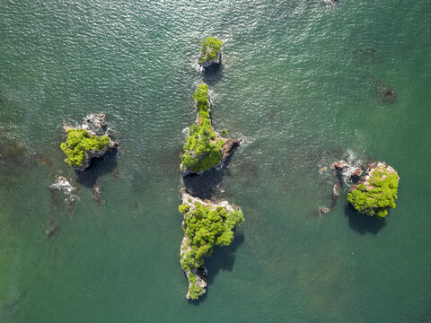 Aerial view of small islands with vibrant green vegetation rising from the turquoise waters of the Limbe River, Bota Island, South West, Cameroon.