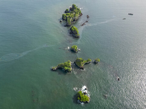 Aerial view of Bota Island, a chain of lush, verdant islets contrasting with the turquoise waters of the Limbe River, South West, Cameroon.