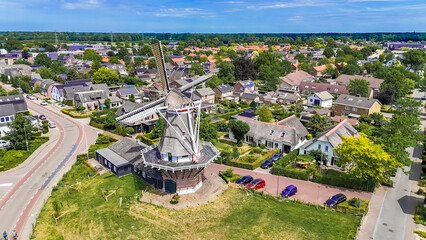 Aerial photo Dutch vintage windmill and turning blades. will take place mill is located in Twello village near Deventer in center of Holland. High quality photo