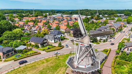 Aerial photo Dutch vintage windmill and turning blades. will take place mill is located in Twello village near Deventer in center of Holland. High quality photo