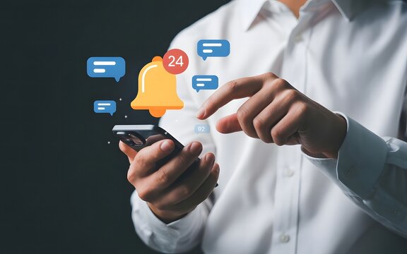 A person is using a smartphone to check notifications from social media and online networks - Powered by Adobe