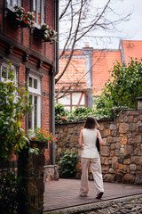 Woman Walking Through Quaint Alley with Laptop Sleeve