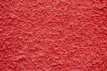 Vivid red stucco wall with rough texture, perfect for backgrounds, posters, and modern graphic projects. Ideal for architectural details and vibrant visual concepts.