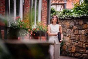 Woman Walking Down Quaint Alley with Laptop Sleeve