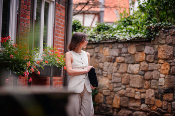 Woman Walking Down Quaint Alley with Laptop Sleeve