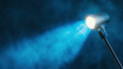 Obraz premium Dramatic Spotlight Illuminating Blue Smoke in Dark Space for Stage, Theater, or Event Lighting Atmosphere Creation and Visual Enhancement