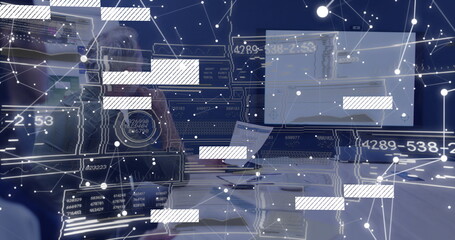 Typing man in button-down shirt at office desk using keyboard and monitor with overlay, copy space