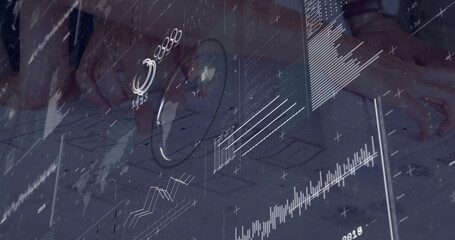 Designer hands overlaying charts on wireframe sketches at work desk, with smartwatch ring