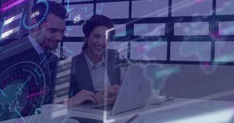 Smiling colleagues in business attire reviewing chart overlay on laptop at office, with coffee cup