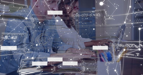Coworkers wearing casual business attire analyzing data on laptop in office with network overlay